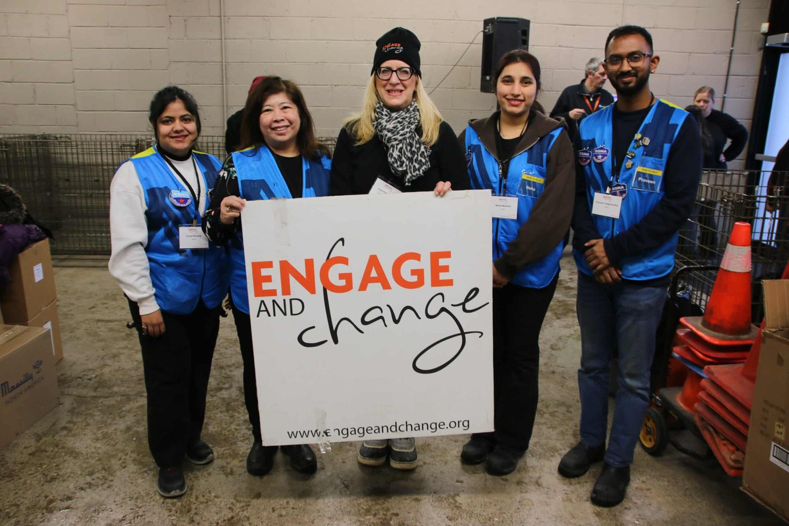 Volunteer team holding the Engage and Change banner