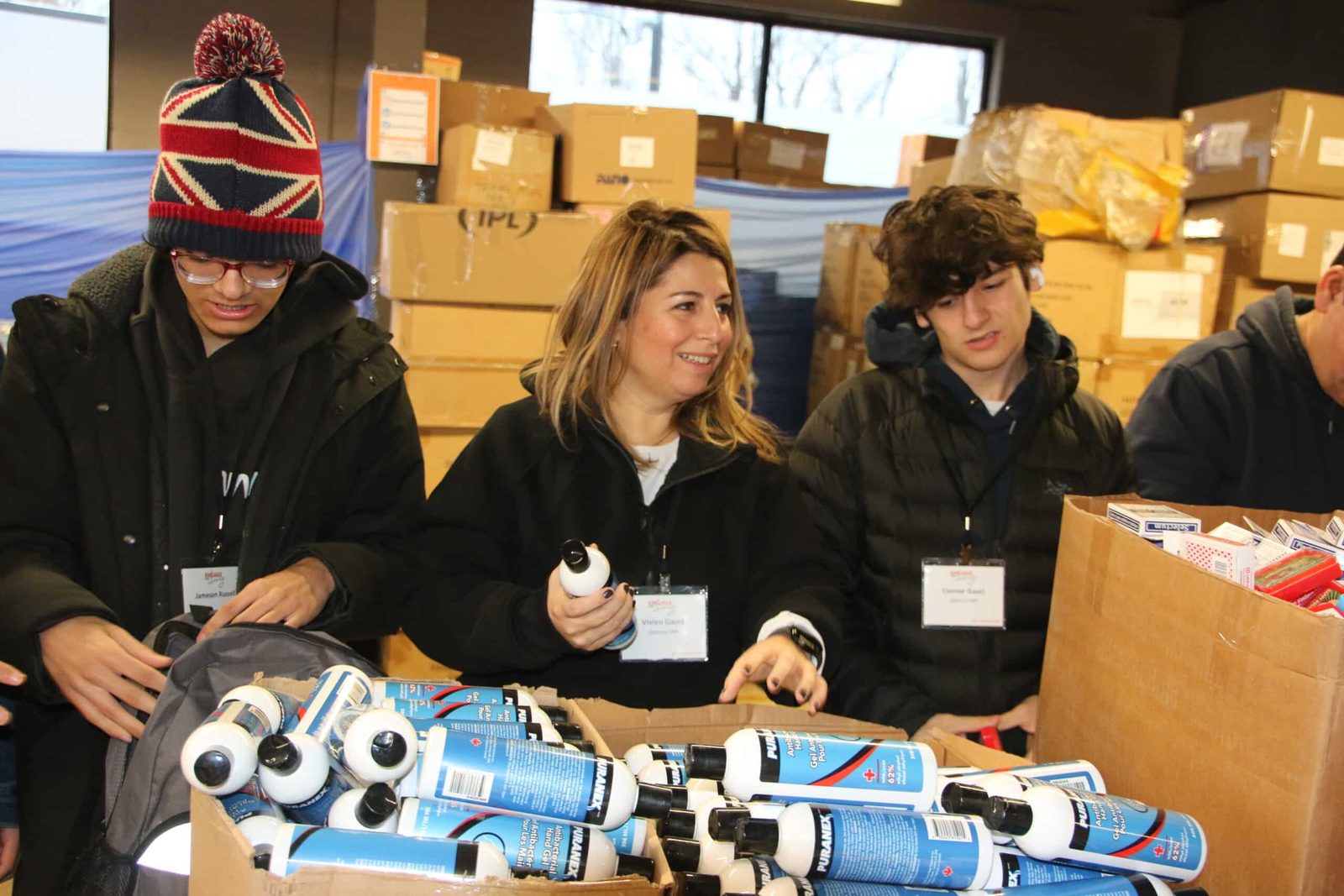 Volunteers packing water bottles and socks into kits